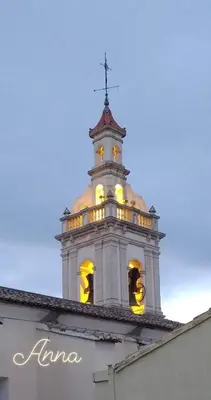 a tower with a cross on top of a building at PALACIO Boutique in Anna