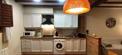 a kitchen with a sink and a microwave at Masía de San Juan Casas número 3 y 5, con piscina, aire acondicionado y vistas a la montaña in Segorbe