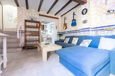 a living room with a blue couch and a table at Boutique House Alzira in Alzira