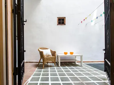 a patio with a table and two chairs and flags at Total Valencia Charming in Valencia