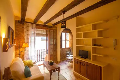 a living room with a couch and a tv at Total Valencia Charming in Valencia