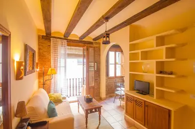 a living room with a couch and a tv at Total Valencia Charming in Valencia