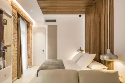a bedroom with a bed and a couch in a room at Mon Suites Benlliure in Valencia