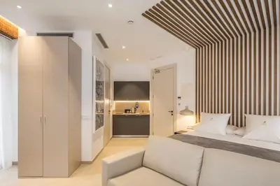 a bedroom with a white bed and a couch at Mon Suites Benlliure in Valencia