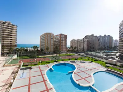 a large swimming pool in a city with tall buildings at Apartment Ana by Interhome in Cullera