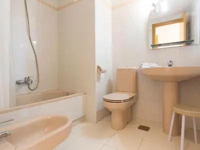 a bathroom with a toilet and a sink and a bath tub at Apartment Ana by Interhome in Cullera