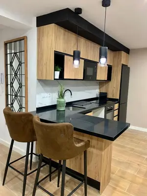 a kitchen with a black counter top and a table at UIM Mediterraneo Buenavista Wifi in Puerto de Sagunto