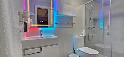 a bathroom with a toilet and a sink and a shower at A45 ViviendaTurísticaValencia Mundo in Valencia