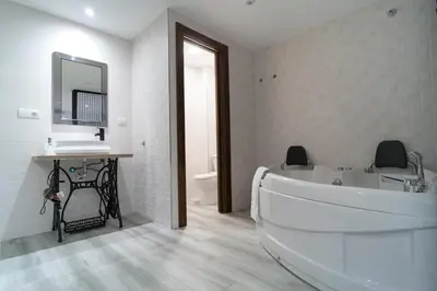 a bathroom with a tub and a sink and a mirror at ROMANTICA in Anna