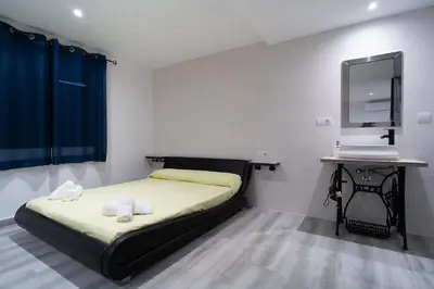 a bedroom with a bed and a desk and a mirror at ROMANTICA in Anna