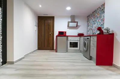 a kitchen with a washing machine and a wooden door at ROMANTICA in Anna