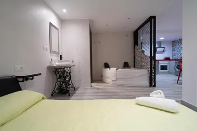 a bedroom with a tub and a bed and a bathroom at ROMANTICA in Anna