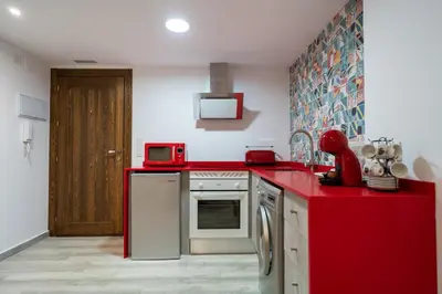 a kitchen with red counters and a red counter top at ROMANTICA in Anna