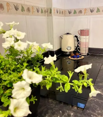 a kitchen with a counter with white flowers on it at Apartamento Mar y Montaña in Cullera