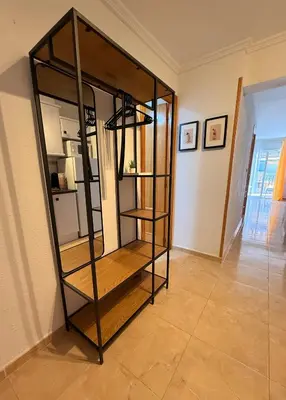 a metal wall with a pay phone in a elevator at Apartamento Mar y Montaña in Cullera