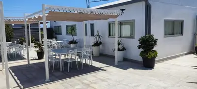 a patio with tables and chairs under a pergola at Hotel Ruta Romana in Sagunto