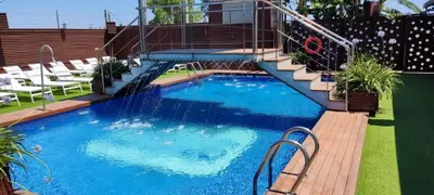 a swimming pool with stairs and a water slide at Hotel Ruta Romana in Sagunto