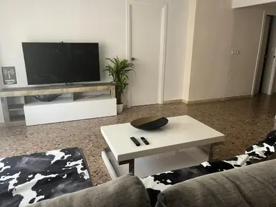 a living room with a tv and a coffee table at Don Quijote CABANAL in Cullera