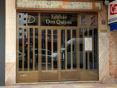 a door to a donut shop with cars behind it at Don Quijote CABANAL in Cullera