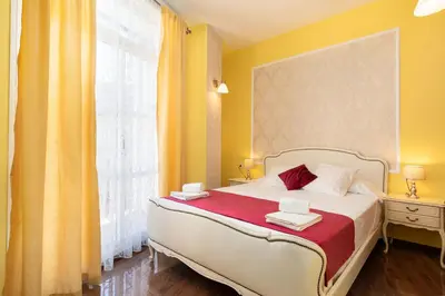 a bedroom with a white bed with towels on it at Adarve Flats in Valencia
