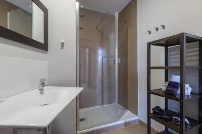 a bathroom with a toilet and a sink and a shower at Adarve Flats in Valencia