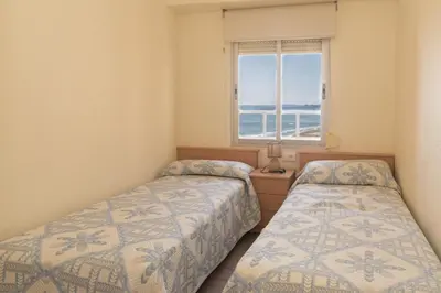 two beds in a room with a window at El Raco, A-7-13 in Cullera