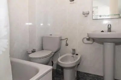 a white bathroom with a toilet and a sink at El Raco, B-8-15 in Cullera