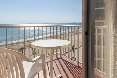 a balcony with a table and a view of the beach at El Raco, B-8-15 in Cullera