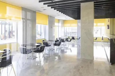 a room with tables and chairs in a building at Florazar-3, 14-E in Cullera