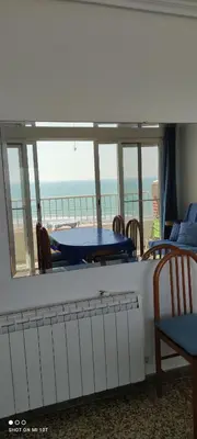 a room with a balcony with a table and chairs at 1ere soleil levant in Puerto de Sagunto