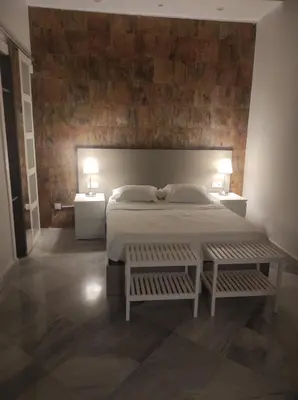 a bedroom with a large bed with two tables and two lamps at APARTAMENTOS En Plom in Valencia