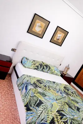 a bedroom with a bed and two pictures on the wall at Habitacion privada Valencia in Valencia