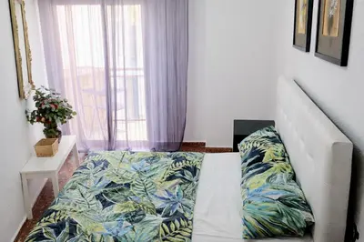 a living room with a couch and a bed at Habitacion privada Valencia in Valencia