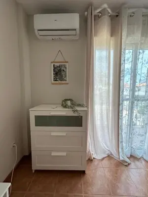 a white dresser in a room with a window at CASA MANUELA in Chella