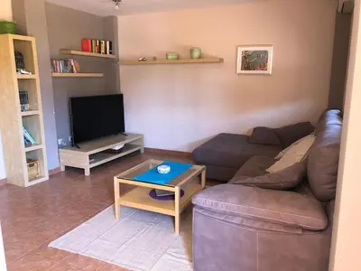 a living room with a couch and a tv at CASA MANUELA in Chella