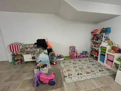 a room filled with toys and a room with a rug at CASA MANUELA in Chella