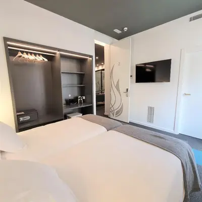 a bedroom with two beds and a flat screen tv at PLAZA VIEW in Valencia