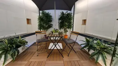 a balcony with a table and chairs and plants at PLAZA VIEW in Valencia