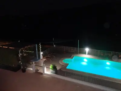 an empty swimming pool at night at LAS PALOMAS, appartement 2 chambres avec piscine in Turís