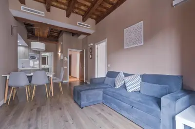 a living room with a blue couch and a table at San Miguel, Luxury apartments. in Valencia