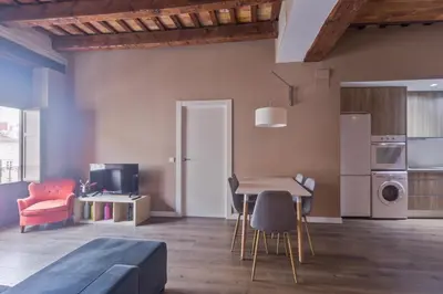 a living room with a bed and a table and chairs at San Miguel, Luxury apartments. in Valencia