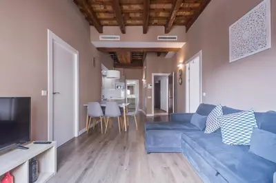 a living room with a blue couch and a table at San Miguel, Luxury apartments. in Valencia