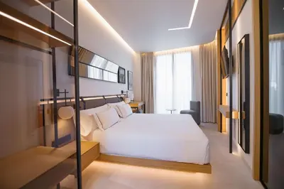a bedroom with a large white bed in a room at MYR Puerta Serranos in Valencia
