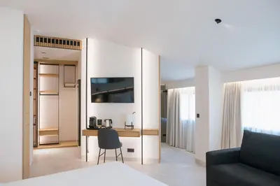 a bedroom with a large white bed and shelves at MYR Puerta Serranos in Valencia