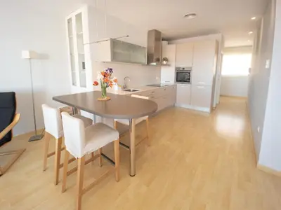 a kitchen with a table and chairs in a room at Valencia Beach Apartments 2 in Valencia