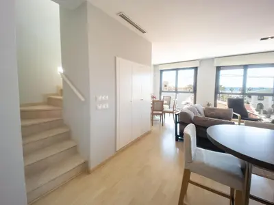 a living room with a staircase and a table at Valencia Beach Apartments 2 in Valencia