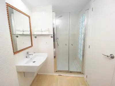 a white bathroom with a sink and a shower at Valencia Beach Apartments 2 in Valencia