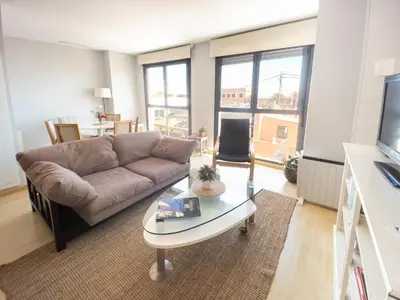 a living room with a couch and a glass table at Valencia Beach Apartments 2 in Valencia