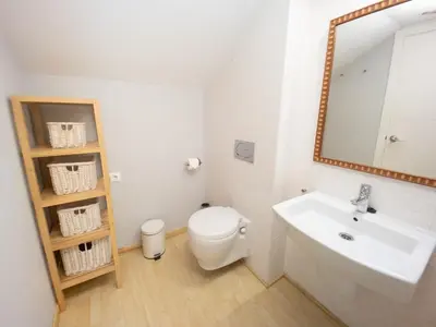 a bathroom with a sink and a toilet and a mirror at Valencia Beach Apartments 2 in Valencia