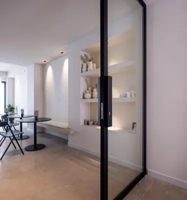 a glass door in a room with a table at YOURS boutique stay in Valencia